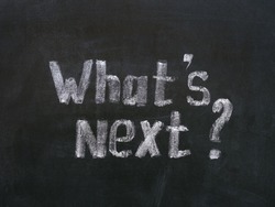 Phrase What`s Next ? written by a chalk on a blackboard