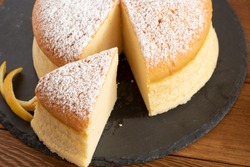 Sponge sponge cake with cheese and lemon, sponge cake with a soft texture. On wooden plate. sugar glaze