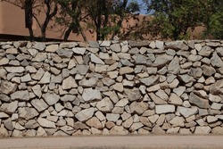 Hand made stonewall. Gray rough stonewall. Abstract stones textured background. Wall ancient construction method.
