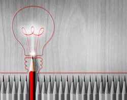 Red pencil drawing light bulb in the middle of the black and white pencil. The concept of energy
