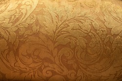 Gold royal brocade paisley patterned fabric background texture