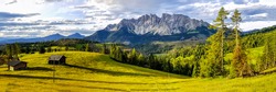 Panorama of a mountain valley with cabins. Mountain panoramic landscape. Beautiful mountain panorama. Mountain panorama
