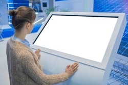 Mock up, copyspace, template, isolated, white screen, futuristic concept. Mockup: woman looking at blank white interactive touchscreen display of electronic kiosk at technology exhibition, museum