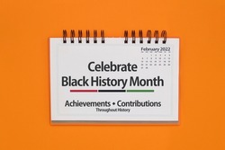 Close up of Celebrate Black History Month sign on orange background