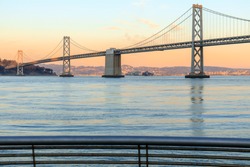 San Francisco Bay Bridge and Pier 14 Rails at Sunset. The Embarcadero, San Francisco, California, USA.