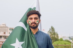 Young Pakistani or Asian Man holding Pakistan Flag, 14th august, Independence Day Pakistan 