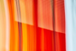 Tiny dot pattern on abstract art of streaks of fiery colors red and orange and red