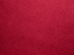 Burgundy red felt texture abstract art background. Colored fabric fibers surface. Empty space.