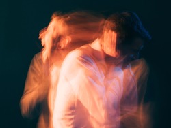 Rage man. Bipolar disorder. Psychology stress. Toxic relationship. Conceptual art portrait. Surreal aggressive screaming guy reflecting each other isolated green blur light double exposure.