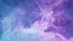 Glitter fluid splash. Neon mist texture. Fantasy explosion. Fluorescent glowing purple blue color shiny ink water splatter over ice cube on vapor cloud abstract background.