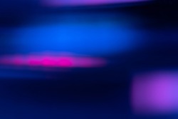 Defocused light flare. Neon abstract background. Futuristic illumination. Blur fluorescent navy blue pink purple color glowing flecks on modern cyber overlay.