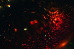 Defocused glow. Red bokeh abstract art background. Colored lens flare. Blurred flashy lights