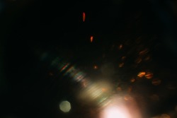 Blurred glow. Dark art background. Colored optical lens flare. Abstract design.