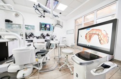 Interior of stomatology cabinet with modern equipment, dental intraoral scanner with teeth on display. Dental office with highly effective medical system for intraoral scanning. Concept of dentistry