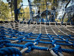 Rope climbing net on the park
 Adventure rope park. Extreme sport in adventure park. Summer vacations. Outdoors playground, leisure for kids.