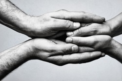 Concept of caring, tenderness, protection. Male and female hands touch each other.