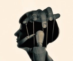 Marionette in woman head, black and white. Concept of mind control. Image