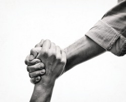 A human's hand saving the another human. Black and white image. Concept of salvation, donorship, helping hand.