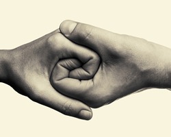 Male and female hands connected with each other  together and forever. This black and white Image is toned and isolated for easy  transfer in your design.