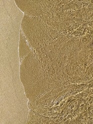 The texture of the water in the sea. wet sand. wet sand texture