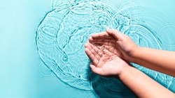 Woman washing cleaning hands by both two hands purity transparent water blue background copy space. People lifestyle hygiene medical nature protective wellness. World environment day World water day