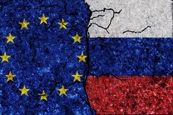Russia and European Union painted flags on a wall with grunge texture. Russia and European Union conflict. EU and Russia flags together. Russia vs EU