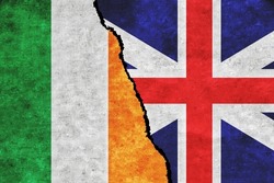 Britain and Ireland painted flags on a wall with a crack. Britain and Ireland conflict. Ireland and Britain flags together. Britain vs Ireland