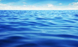 Blue sea water. Ocean surface natural background on sky