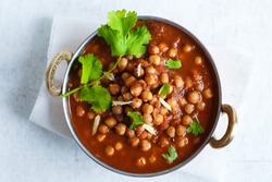 Chana Masala - Spicy Chickpea Curry , Indian Dish
Chickpeas soaking in a bed of Onion Tomato gravy, garnished with Coriander leaves and Ginger Juliennes