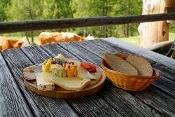 a rustic meal of cheeses and cold cuts in the Austrian Alps of the Schladming-Dachstein region (Styria in Austria)                               