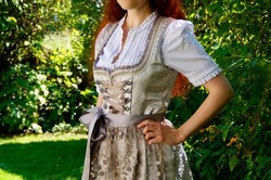 a girl in a beautiful traditional Bavarian or also Austrian dirndl dress (Tracht) (Munich, Bavaria, Germany)	                              