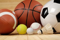 sports balls on wooden background