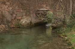 Ancient Roman stone bridge where water flows to other lagoons.