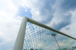 Soccer goal against a cloudy sky background.