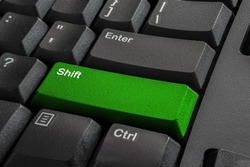 Close-up the Shift button on the classic keyboard and have Lime, Green color button isolate black keyboard. High quality photo.