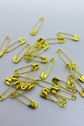 golden safety pins for seewing. A safety pin is a bent metal pin used for fastening things together
