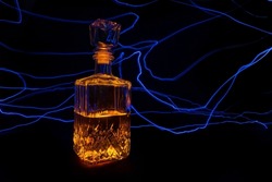 bottle illuminated by arched lines of light