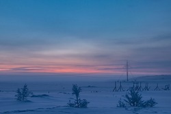 Radio mast and power lines. Noon, polar dawn, Murmansk region, Far North, Russia, Arctic