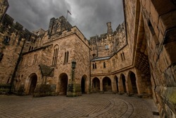 Nice view of an inner courtyard of alnwick castle under a grey overcast and threatening sky, in england