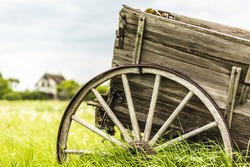 An old broken down wagon abandoned in the field