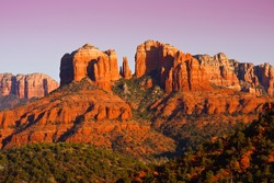 The view of Cathedral Rock in Sedona, Arizona.  The towering rock formations stand out like beacons in the dimmed landscape of the Red Rock State Park.