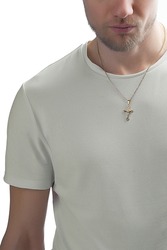 Close-up portrait of a man, demonstrating a gold necklace featuring a cross pendant. The cross is with detailed edge. The man in a bright T-shirt wearing cross pendant necklace on a white background.