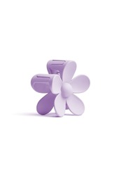 Close-up shot of a violet hair claw clip. The hair claw clip is featuring a floral design. The flower hair claw clip is isolated on a white background. Side view.