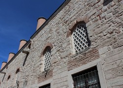 Photograph of mosaic, vintage, ethnic and historical patterned walls and windows in the midday sun and blue sky