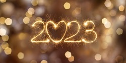 Happy New Year 2023. Beautiful holiday billboard with Sparkling creative text 2023 with heart on festive glowing golden background