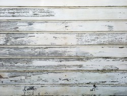 Background of horizontal old white wood slats. Old and weathered white sheets background. Architecture and construction of the French Antilles. Creole style.