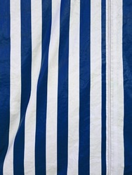 Full frame striped canvas. Vertical blue and white striped awning fabric texture. Vertical striped fabric background. Striped outdoor fabric.