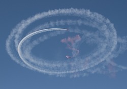 Circular smoke trails from parachutists