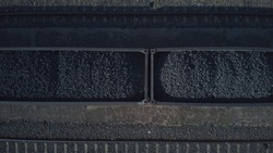 Aerial view on wagons with black coal. Coal transportation. Close up.