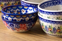 Colorful Polish ceramic pottery, local craft products from Poland. Ceramic plates display close up in Poland. Colorful of vintage ceramic plates in Boleslawiec, Poland